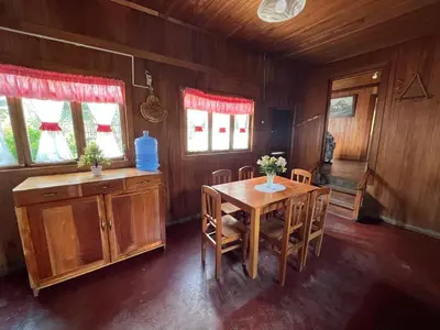 a dining room with a wooden table and chairs at Schütze-Haus in Oxapampa