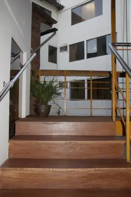 a set of stairs in a building with a potted plant at VILLA andina cusco in Cusco