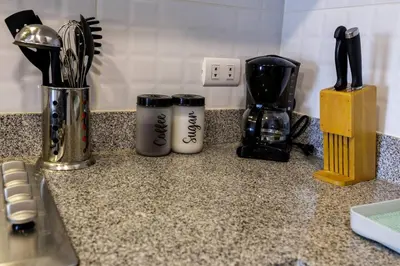 a kitchen counter with two coffee mugs and a blender at BSR Cozy Flat next to Av. Javier Prado w/ Pool&Gym in Lima