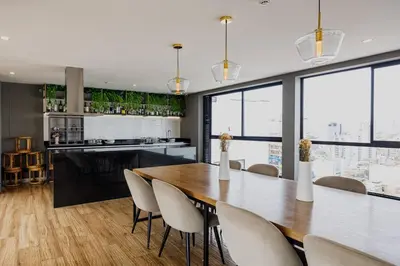 a dining room with a large wooden table and chairs at BSR Cozy Flat next to Av. Javier Prado w/ Pool&Gym in Lima