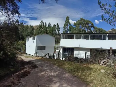 a white building on the side of a road at Hotel Campestre Corina