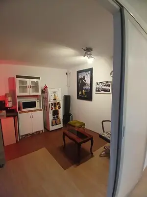 a living room with a table and a refrigerator at Freestyle Home in Lima