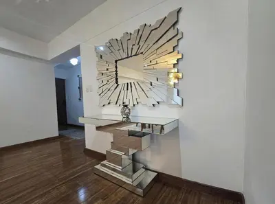a large clock hanging on a wall in a room at E Malecon Larcomar Free Parking 3B 102 in Lima