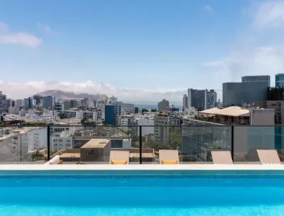 a swimming pool with a view of a city at Acogedor depa 2D 2B cerca a Kennedy y Larcomar in Lima