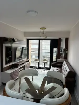 a living room with a couch and a table and chairs at Acogedor depa 2D 2B cerca a Kennedy y Larcomar in Lima