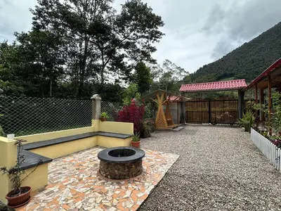 a backyard with a fire pit and a fence at La posada del Minero - Oxapampa in Oxapampa