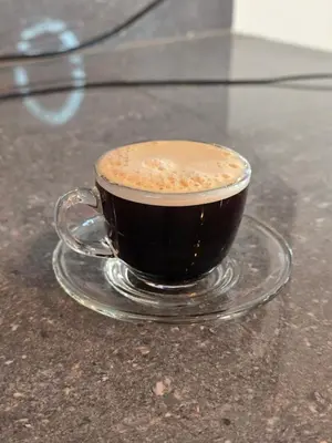 a cup of coffee sitting on a table at In house ica in Ica