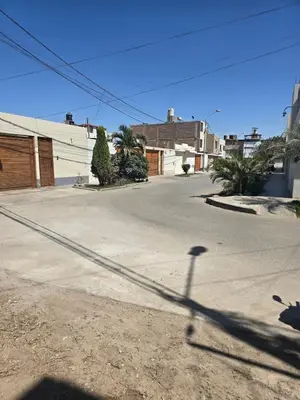 an empty street with a shadow of a pole at In house ica in Ica