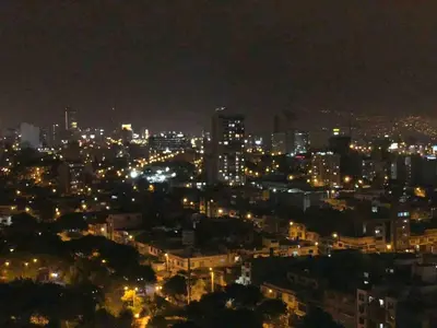 a view of a city at night with lights at Urbana Perú Tempo in Lima