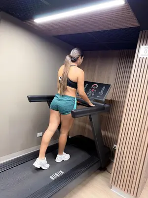a woman standing on a treadmill in a gym at The Sight in Lima