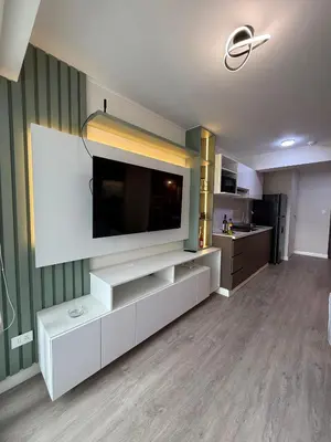 a living room with a large television on a wall at The Sight in Lima