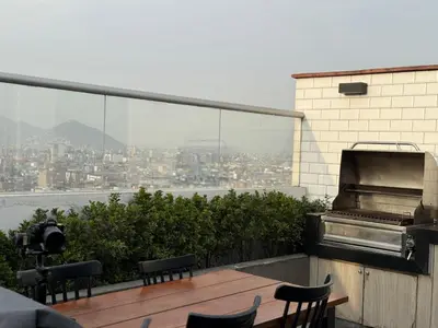 a balcony with chairs and a view of a city at Casa viajera - orla los topacios in Lima