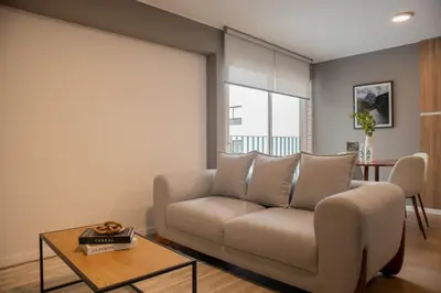 a living room with a couch and a table at Fanning Apartments by Wynwood House in Lima
