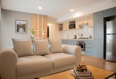 a living room with a couch and a kitchen at Fanning Apartments by Wynwood House in Lima