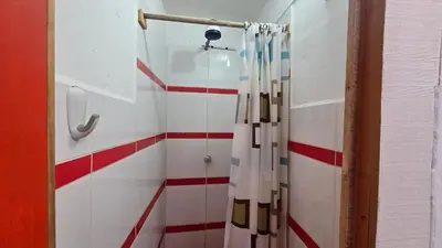a shower with a curtain in a bathroom at Refugio Sagrado Boutique in Ollantaytambo