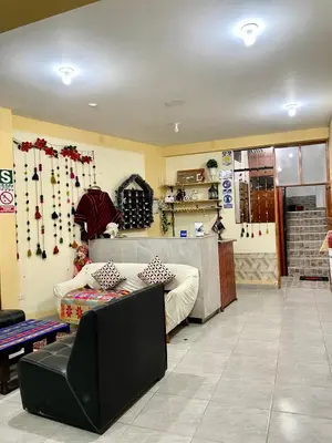 a living room with a couch and a table at TORIBIANS Hotel in Chinchero