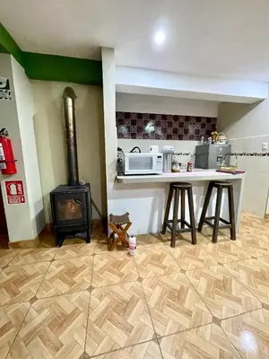 a kitchen with a stove and a counter with a stove at TORIBIANS Hotel in Chinchero