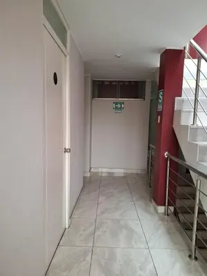 a hallway with a white door and a basketball hoop at Hospedaje El Jardín in Lima