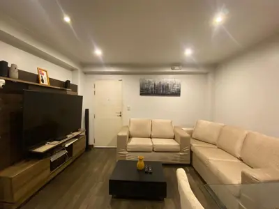 a living room with a couch and a flat screen tv at Casa Olivo in Lima