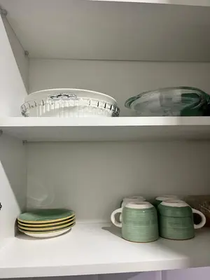 a shelf with plates and bowls in a kitchen at Miraflores premiere apartment in Lima