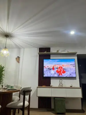 a living room with a flat screen tv at Miraflores premiere apartment in Lima