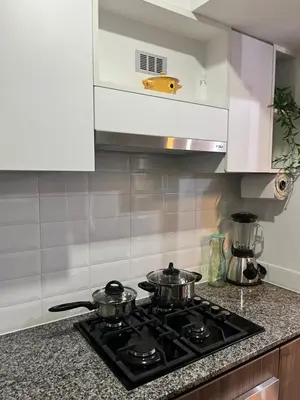 two pots on a stove top in a kitchen at Miraflores premiere apartment in Lima