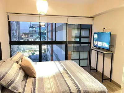 a bedroom with a bed and a flat screen tv at Era 24 mala puntuacion in Lima