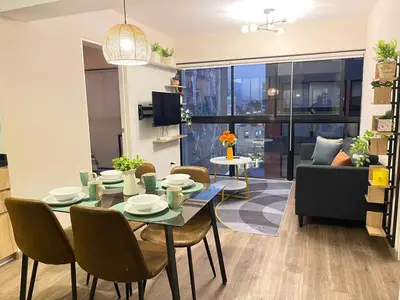a living room with a table and chairs and a couch at Era 24 mala puntuacion in Lima