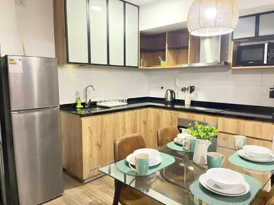 a kitchen with a table and a stainless steel refrigerator at Era 24 mala puntuacion in Lima