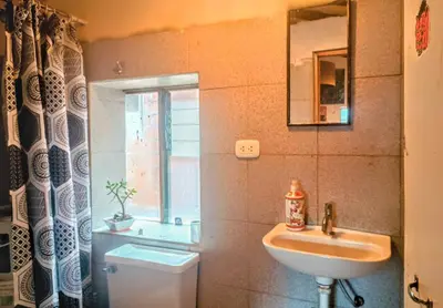 a bathroom with a sink and a toilet and a mirror at Yuntawasi Cozy mini Ollantaytambo in Ollantaytambo