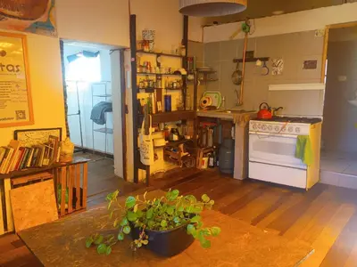 a kitchen with a table with a potted plant at Yuntawasi Cozy mini Ollantaytambo in Ollantaytambo