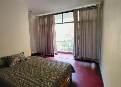 a bedroom with a bed and a large window at Casa familiar con parrilla, piscina, WiFi y cesped