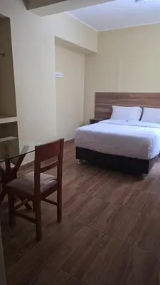 a bedroom with a bed and a table and a chair at MOON Edificio in San Vicente de Cañete