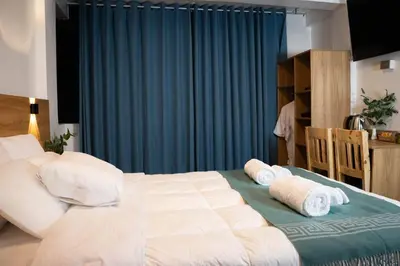 a bedroom with a large bed with towels on it at Velvet Sunrise Hotel in Machu Picchu
