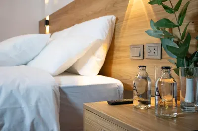 a bedroom with a bed and two glass bottles on a table at Velvet Sunrise Hotel in Machu Picchu