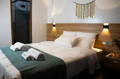 a bedroom with a large bed with towels on it at Velvet Sunrise Hotel in Machu Picchu