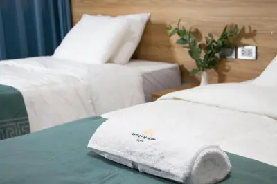 a hotel room with two beds with white towels at Velvet Sunrise Hotel in Machu Picchu