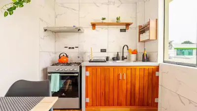 a kitchen with a stove and a sink at Loft equipado y acogedor con Terraza en Matellini in Lima