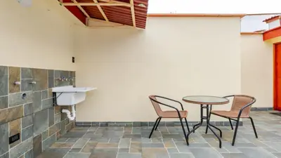 a patio with a table and chairs and a sink at Loft equipado y acogedor con Terraza en Matellini in Lima