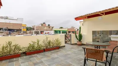 a patio with a table and chairs on a balcony at Loft equipado y acogedor con Terraza en Matellini in Lima