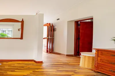 a hallway with a red door and a wooden floor at Loft equipado y acogedor con Terraza en Matellini in Lima
