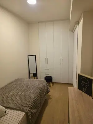 a bedroom with a bed and white cabinets at Habitación en Apartamento Pueblo Libre in Lima