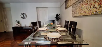 a dining room with a glass table and chairs at Habitación Pequeña dentro departamento compartido 402 in Lima