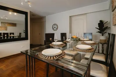 a dining room with a glass table and chairs at Habitación Pequeña dentro departamento compartido 402 in Lima
