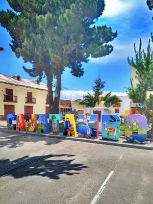 a street with a lot of colorful signs on the side of a road at Hotel Tambo del Inca in Cajatambo