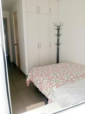 a bedroom with a bed and white cabinets at Aqua y Sol Private Pool Parking Air Conditioning in Playa de Santa María
