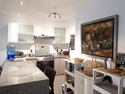 a kitchen with a large painting on the wall at Aqua y Sol Private Pool Parking Air Conditioning in Playa de Santa María