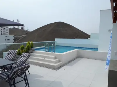 a swimming pool on the roof of a building at Aqua y Sol Private Pool Parking Air Conditioning in Playa de Santa María
