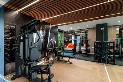 a gym with treadmills and cardio equipment in a room at Artline Terrace Residence in Lima