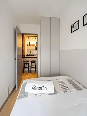 a bedroom with a white bed and a kitchen at Contemporary Great View in Lima